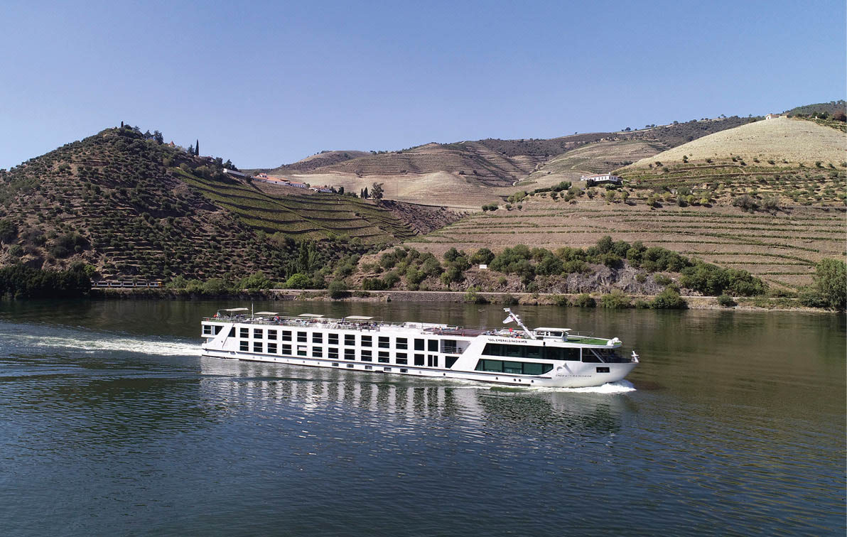 A luxury river ship sailing through the countryside along the Douro River in Portugal