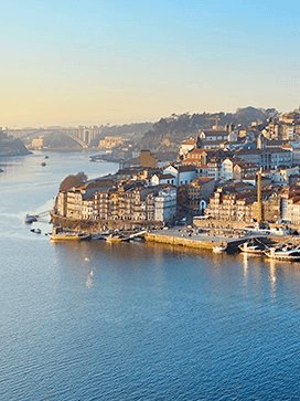 The city of Porto at sunset sat proudly next to the Douro River