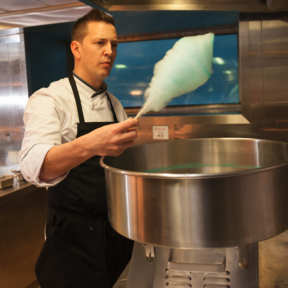 Chef Tom Goetter making cotton candy in kitchen